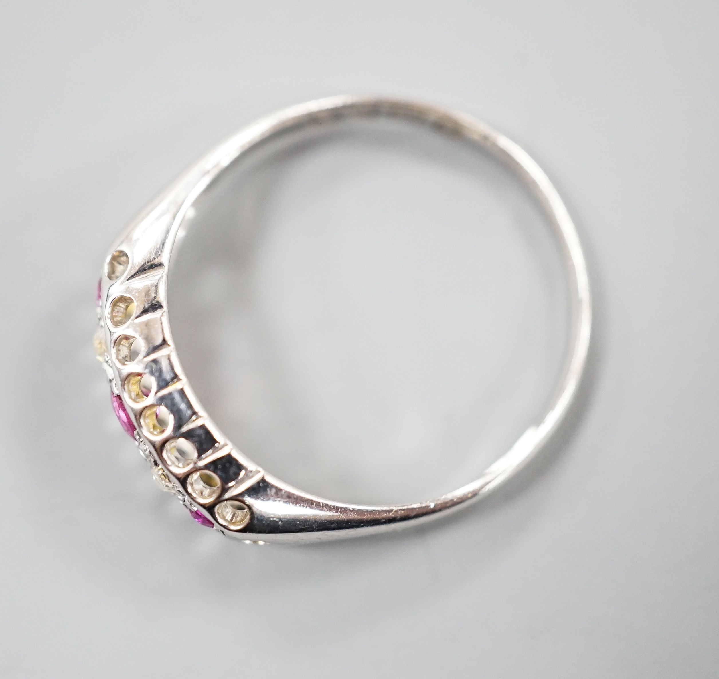 A George V 18ct white gold three stone ruby and two stone diamond ring, size P/Q, gross weight 2.3 grams.